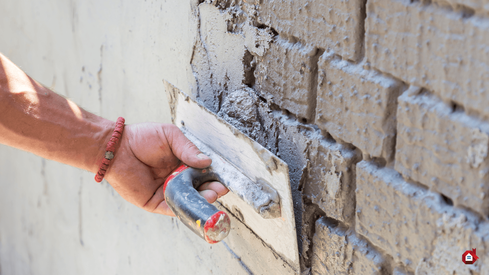 entrepreneur mettant du crépi sur un mur